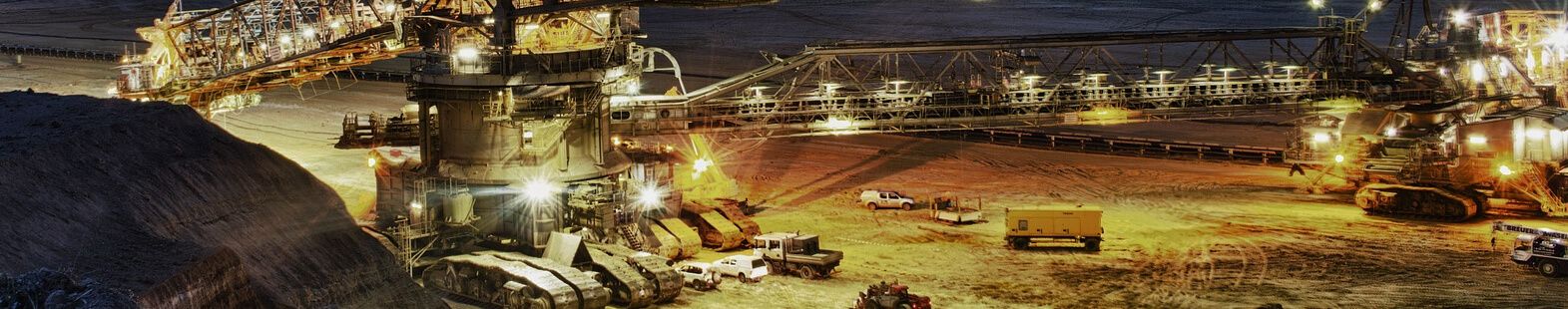 Open pit mine at night with excavators