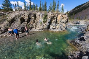 Photo shows a a family swimming in a mountain river, Canada's top ten weather stories 2017 by David Phillips