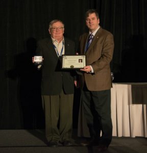 Photo shows two men, one is presenting a CMOS award to the other (Martin Taillefer and Paul André Bolduc.