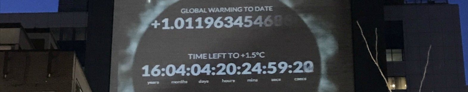 Photo shows a projection of the climate clock on the side of a building for the article by Samantha Mailhot for the CMOS Bulletin.