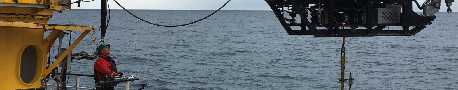 Man on a research vessel directing a part of the vessel