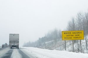 Photo shows a transport trailer driving down a snowy highway, Canada's top ten weather stories 2017 by David Phillips