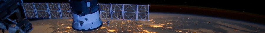 Photo shows a satellite in space, at night, with a view of land below studded with lights, for an update for CMOS members on the GWE conference.