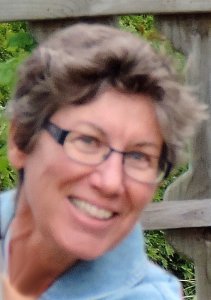 Photo of Rebecca Milo, smiling woman with short hair and glasses, author of women in meteorology