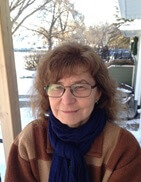 Photo of JEannine-Marie St-Jacques, a middle aged woman with brown hair and glasses