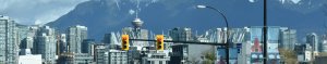 skyscraper view of traffic lights and Vancouver tower