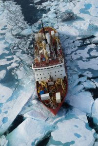 Areal photo of the icebreaker in the ocean with broken ice all around